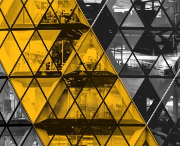 Front of The Gherkin, London, with a view into office spaces