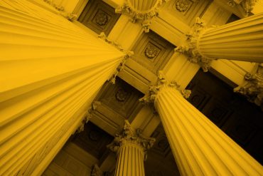 Upwards photo of bank or finance building columns