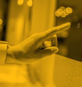 Woman reaching out index finger to press button on glass screen