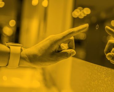 Woman reaching out index finger to press button on glass screen