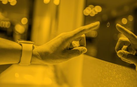Woman reaching out index finger to press button on glass screen