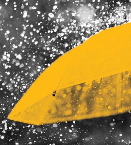 Abstract image of yellow umbrella in rain