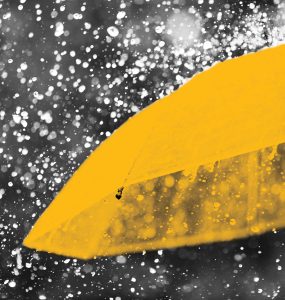 Abstract image of yellow umbrella in rain