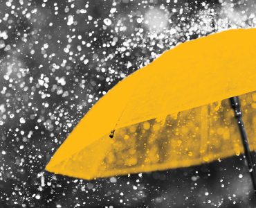 Abstract image of yellow umbrella in rain