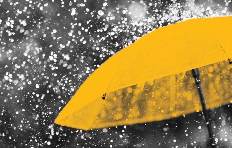 Abstract image of yellow umbrella in rain