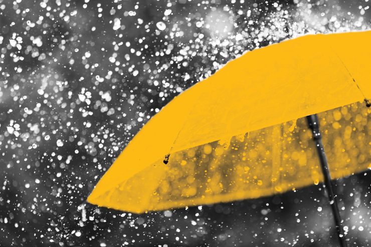 Abstract image of yellow umbrella in rain